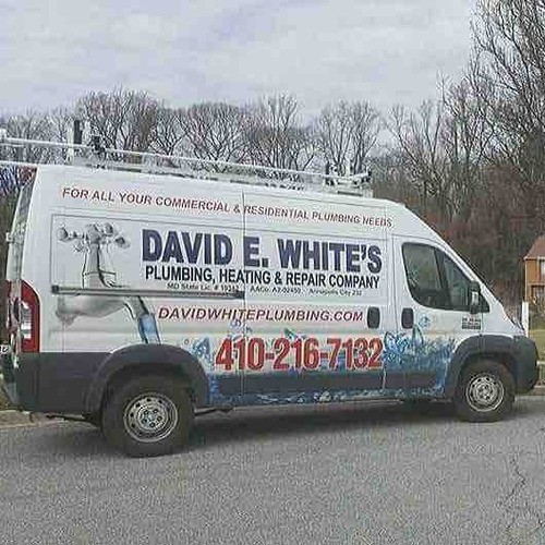 white plumbing van with company logo
